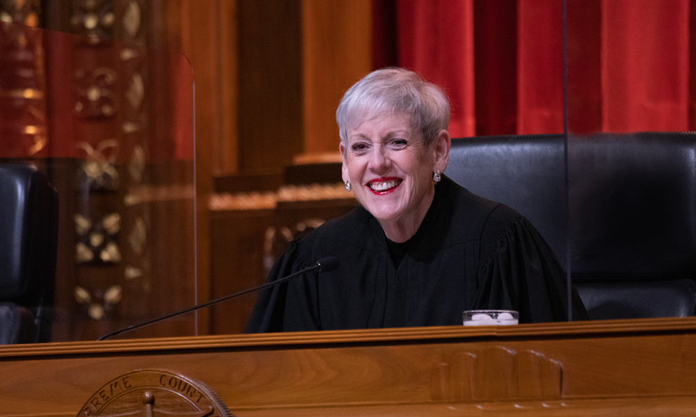 Image of Ohio Supreme Court Chief Justice Maureen O'Connor smiling from the bench in the courtroom of the Thomas J. Moyer Ohio Judicial Center
