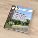 Image showing a booklet with a picture of the Thomas J. Moyer Ohio Judicial Center on the cover sitting on a wooden surface.